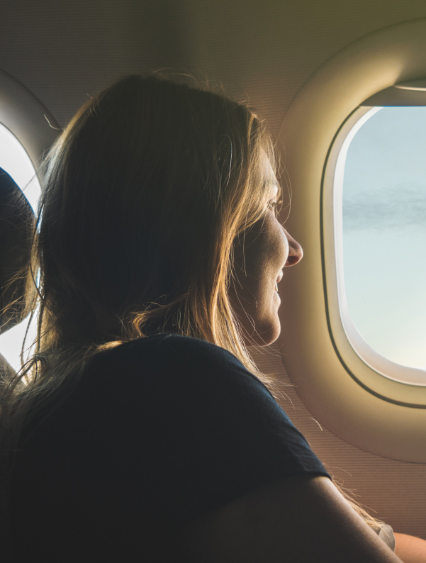 woman looking outside the airplane window